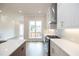 Modern kitchen with white cabinets, quartz countertops, and stainless steel appliances at 620 Goldsmith Ct # 107, Johns Creek, GA 30022