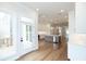 Open kitchen with island, stainless steel appliances, and hardwood floors at 620 Goldsmith Ct # 107, Johns Creek, GA 30022