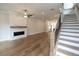 Spacious living room with hardwood floors, fireplace, and stunning staircase at 620 Goldsmith Ct # 107, Johns Creek, GA 30022