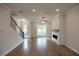 Hardwood floors, fireplace, and staircase in this open living room at 620 Goldsmith Ct # 107, Johns Creek, GA 30022