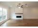Light-filled living room featuring hardwood floors and a fireplace at 620 Goldsmith Ct # 107, Johns Creek, GA 30022