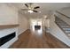 Open living room with hardwood floors, fireplace, and view into kitchen at 620 Goldsmith Ct # 107, Johns Creek, GA 30022