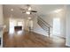 Bright living area with hardwood floors and a view of the staircase at 620 Goldsmith Ct # 107, Johns Creek, GA 30022