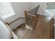 Modern staircase features hardwood floors and a metal railing at 620 Goldsmith Ct # 107, Johns Creek, GA 30022