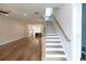 Bright entryway with hardwood floors and a staircase leading upstairs at 620 Goldsmith Ct # 107, Johns Creek, GA 30022