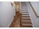 Stylish staircase connecting the floors with hardwood flooring at 620 Goldsmith Ct # 107, Johns Creek, GA 30022