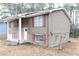 Side view of a ranch home with red shutters and mature trees at 6540 Connell Rd, Atlanta, GA 30349