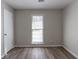 Simple bedroom with large window and wood-look floors at 5725 Twain Dr, Ellenwood, GA 30294