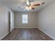 Simple bedroom with large window and wood-look floors at 5725 Twain Dr, Ellenwood, GA 30294