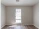 Simple bedroom with large window and wood-look floors at 5725 Twain Dr, Ellenwood, GA 30294