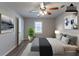 Virtually staged bedroom with a ceiling fan and large window at 5725 Twain Dr, Ellenwood, GA 30294