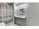 Modern bathroom with gray vanity, marble countertop and shower/tub at 1400 Cresthaven Ln, Lawrenceville, GA 30043