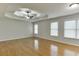 Main bedroom with hardwood floors, tray ceiling, and multiple windows at 1400 Cresthaven Ln, Lawrenceville, GA 30043