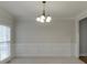 Formal dining room with wainscoting and chandelier at 1400 Cresthaven Ln, Lawrenceville, GA 30043