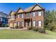 Two-story house with brick facade, three-car garage, and manicured lawn at 1400 Cresthaven Ln, Lawrenceville, GA 30043