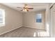 Neutral bedroom featuring plush carpet, a ceiling fan, and natural light from the window at 1927 Cindy Dr, Decatur, GA 30032