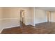 Open-concept living space with wood-look floors, neutral walls, and access to the kitchen at 1927 Cindy Dr, Decatur, GA 30032