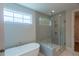 Elegant bathroom featuring a freestanding tub, separate shower, and stylish fixtures at 5320 Memento Trace, Cumming, GA 30040
