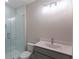 Modern bathroom featuring glass shower, sleek vanity, and bright lighting fixtures at 5320 Memento Trace, Cumming, GA 30040