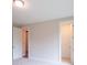 Bright bedroom featuring neutral walls, plush carpet, and simple ceiling light at 5320 Memento Trace, Cumming, GA 30040