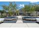A lovely outdoor gathering area with a beautiful clubhouse, seating, and well-manicured landscaping at 5320 Memento Trace, Cumming, GA 30040