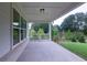 Covered patio with gray brick foundation and exterior featuring a great view of the surrounding backyard and greenery at 5320 Memento Trace, Cumming, GA 30040