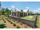 A charming home features a spacious porch, manicured lawn, and stylish design elements at 5320 Memento Trace, Cumming, GA 30040
