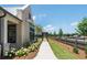 This home's walkway lined with hydrangeas leads to backyard with pergola, fencing, and a well-maintained yard at 5320 Memento Trace, Cumming, GA 30040