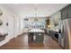 Kitchen featuring stainless steel appliances, granite countertops, and a spacious island, with seating at 5320 Memento Trace, Cumming, GA 30040