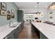 Modern kitchen with a large island, stainless steel appliances, and view to living area at 5320 Memento Trace, Cumming, GA 30040