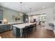 Open kitchen with a large island, stainless steel appliances, and seamless flow to living area at 5320 Memento Trace, Cumming, GA 30040