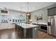 Modern kitchen with stainless steel appliances, granite countertops, and a large island, with seating at 5320 Memento Trace, Cumming, GA 30040