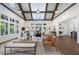 Bright living room featuring vaulted ceilings with wood beams and a cozy seating area bathed in natural light at 5320 Memento Trace, Cumming, GA 30040