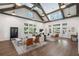 Spacious living room with hardwood floors, vaulted ceilings, and a comfortable seating arrangement at 5320 Memento Trace, Cumming, GA 30040