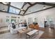 Bright and airy living room with a vaulted ceiling, complete with a sofa, chairs, and a rustic coffee table at 5320 Memento Trace, Cumming, GA 30040