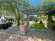Outdoor lounge area with metal pergola, stone columns, and swinging bench, offering a relaxing public gathering space at 5320 Memento Trace, Cumming, GA 30040
