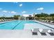 Spacious community pool area with lounge chairs and a nearby building at 5320 Memento Trace, Cumming, GA 30040