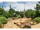 Veterans memorial featuring a statue, American flag, and water feature landscaped with rocks, bushes, and flowers at 5320 Memento Trace, Cumming, GA 30040