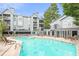 Refreshing community pool area with surrounding lounge chairs at 534 Granville Ct, Atlanta, GA 30328