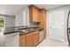Modern kitchen with light wood cabinets, granite countertops, and stainless steel appliances at 534 Granville Ct, Atlanta, GA 30328