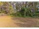 View of a mostly grassy backyard with some trees at 7133 Pineview Sw Dr, Covington, GA 30014
