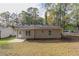 House backyard with grassy area and concrete patio at 7133 Pineview Sw Dr, Covington, GA 30014