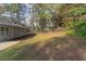 Large backyard with grass and trees behind a tan house at 7133 Pineview Sw Dr, Covington, GA 30014