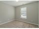Cozy carpeted bedroom with a window and neutral walls at 7133 Pineview Sw Dr, Covington, GA 30014