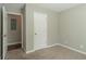 Carpeted bedroom with closet and access to another room at 7133 Pineview Sw Dr, Covington, GA 30014