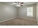 Bedroom with ceiling fan, window, and neutral walls at 7133 Pineview Sw Dr, Covington, GA 30014