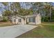 Front view of a charming house with a concrete driveway and grassy yard at 7133 Pineview Sw Dr, Covington, GA 30014