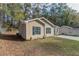 Side view of house, showcasing the neutral color scheme and landscaping at 7133 Pineview Sw Dr, Covington, GA 30014