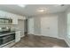 Eat-in kitchen with white cabinets, granite countertops, and stainless steel appliances at 7133 Pineview Sw Dr, Covington, GA 30014