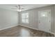 Living room with gray walls, wood-look floors, and a ceiling fan at 7133 Pineview Sw Dr, Covington, GA 30014